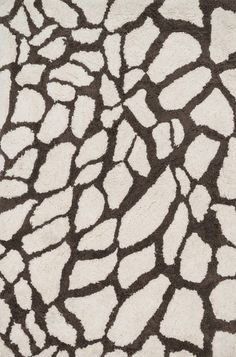 an animal print rug with white and brown colors