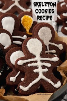 An up-close image of a a bowl filled with chocolate cookies in a skeleton shape with skeleton decorations Skeleton Cookies, Easy Halloween Cookies, Ghosts And Goblins, Halloween Cookie Recipes, Easy Halloween Food, Spooky Skeleton