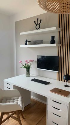 a white desk with a computer monitor and keyboard