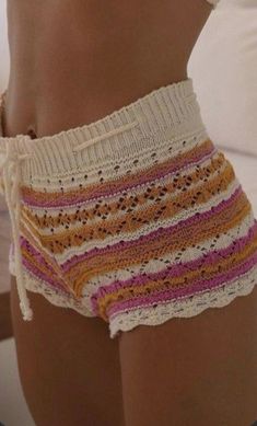 a close up of a woman wearing shorts and panties with her hand on her hip