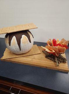 an ice cream sundae sits on top of a cutting board