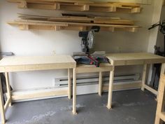 a workbench with tools on it and some shelves in the wall behind it