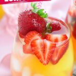 a close up of a drink in a glass with strawberries