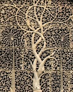 an intricate carving on the side of a building with trees and animals in it's center