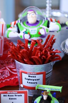 toy story buzz lightyear party favors in tin buckets and candy bar wrappers