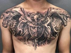 a man with tattoos on his chest and two snakes in the middle of his chest