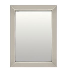 a white framed mirror sitting on top of a wall