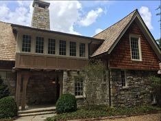 a stone and wood house with a clock tower