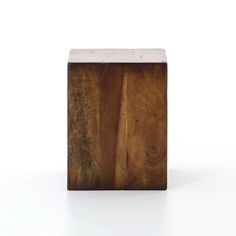 a small wooden block sitting on top of a white surface