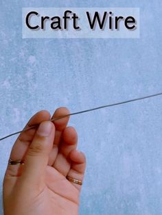 a person holding an object in their hand with the word craft wire above it and below it