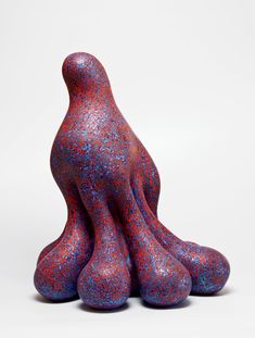 a purple sculpture sitting on top of a white table