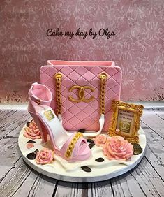 a cake that is shaped like a pink purse and some high heels on top of it