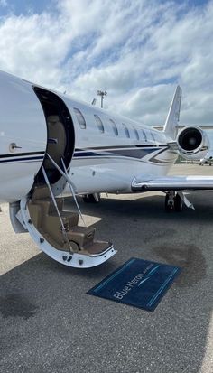 a private jet parked on the tarmac at an airport