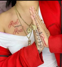 a woman with tattoos on her chest and hands folded in front of her chest is praying