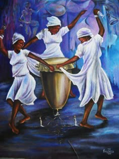 three women in white dresses are dancing around a large metal drum with their hands up