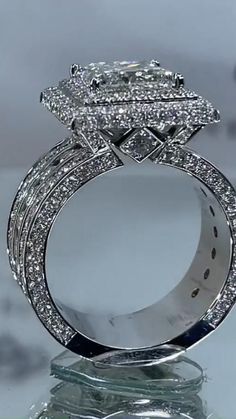 a diamond ring on top of a glass table