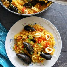 two bowls filled with rice and mussels next to each other