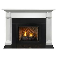 a white fireplace with two lit candles on it's sides and a black mantle