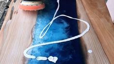 a wooden table topped with blue and white water