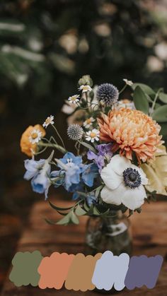 a vase filled with flowers on top of a wooden table