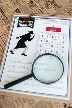 a magnifying glass sitting on top of a piece of paper next to a newspaper