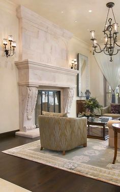 a living room with a fireplace and chandelier