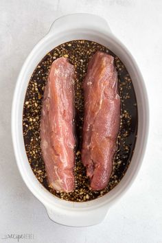 two raw meats in a white bowl with seasoning