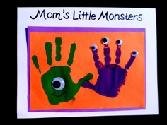 a handprint with two hands and eyes on it that says mom's little monsters