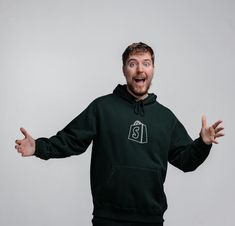 MrBeast gestures with his arms out while wearing a dark green hoodie with the Shopify logo on it Bulk Email, To Start A Business, Start A Business, Starting A Business, A Business