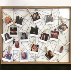 a wooden frame with pictures and clothes pins attached to it