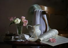 a table topped with flowers next to an open book