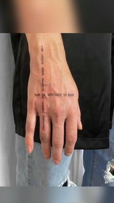 a person with a tattoo on their hand that reads, and the words are written in cursive writing