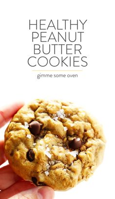 a hand holding a chocolate chip cookie with the title healthy peanut butter cookies gimme some oven