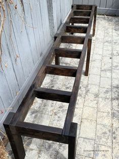 several wooden benches lined up against a wall