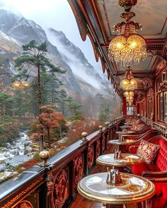 a train car filled with lots of tables and chairs next to a mountain side covered in snow