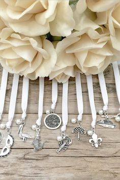 a bunch of white flowers sitting on top of a wooden table next to each other