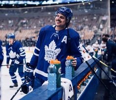 an image of a man that is standing in front of some hockey players on the ice