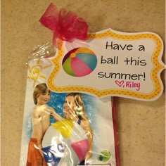 there is a sign that says have a ball this summer with two people on it