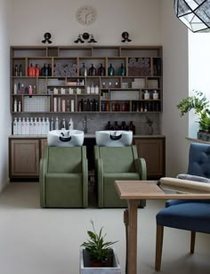 two green chairs sitting in front of a bar