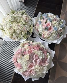 three bouquets of flowers sitting on top of each other