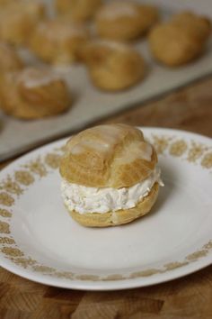 a pastry on a plate next to some muffins