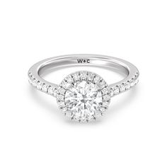 a white gold engagement ring with diamonds on the band and a center stone in the middle