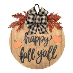 a wooden sign that says happy fall with an orange and black bow hanging from it