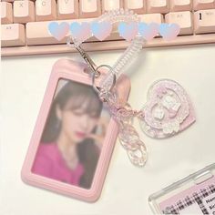 a keychain with a photo attached to it sitting next to a computer keyboard