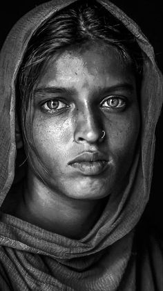 a black and white photo of a woman with freckles on her face