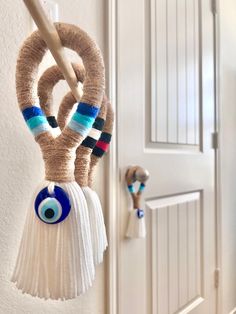 the door handle is made out of yarn and has an evil eye on it's side