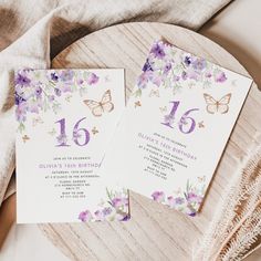 two purple and white wedding cards with butterflies on them