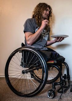 a man in a wheel chair holding a plate