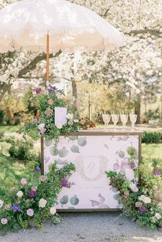 an umbrella is set up in front of a floral display