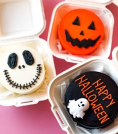 three halloween themed cupcakes in plastic containers